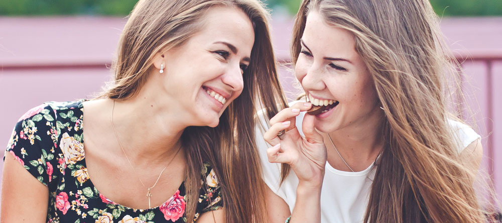 Girls eating Neapolitan Chocolates