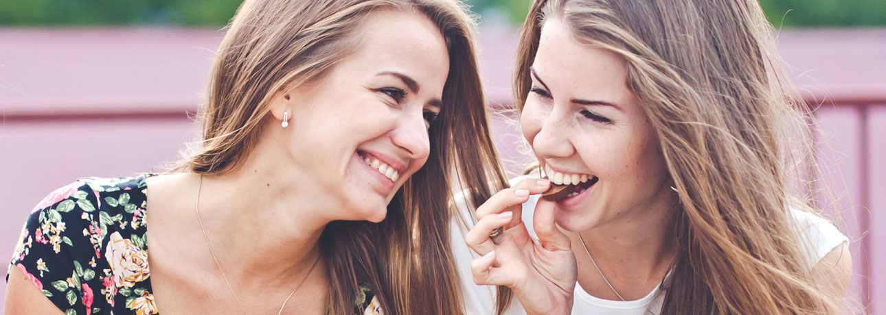 Two girls eating chocolate
